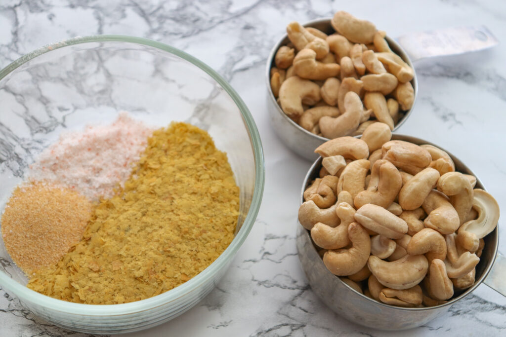 Cashews, spices on marble countertop