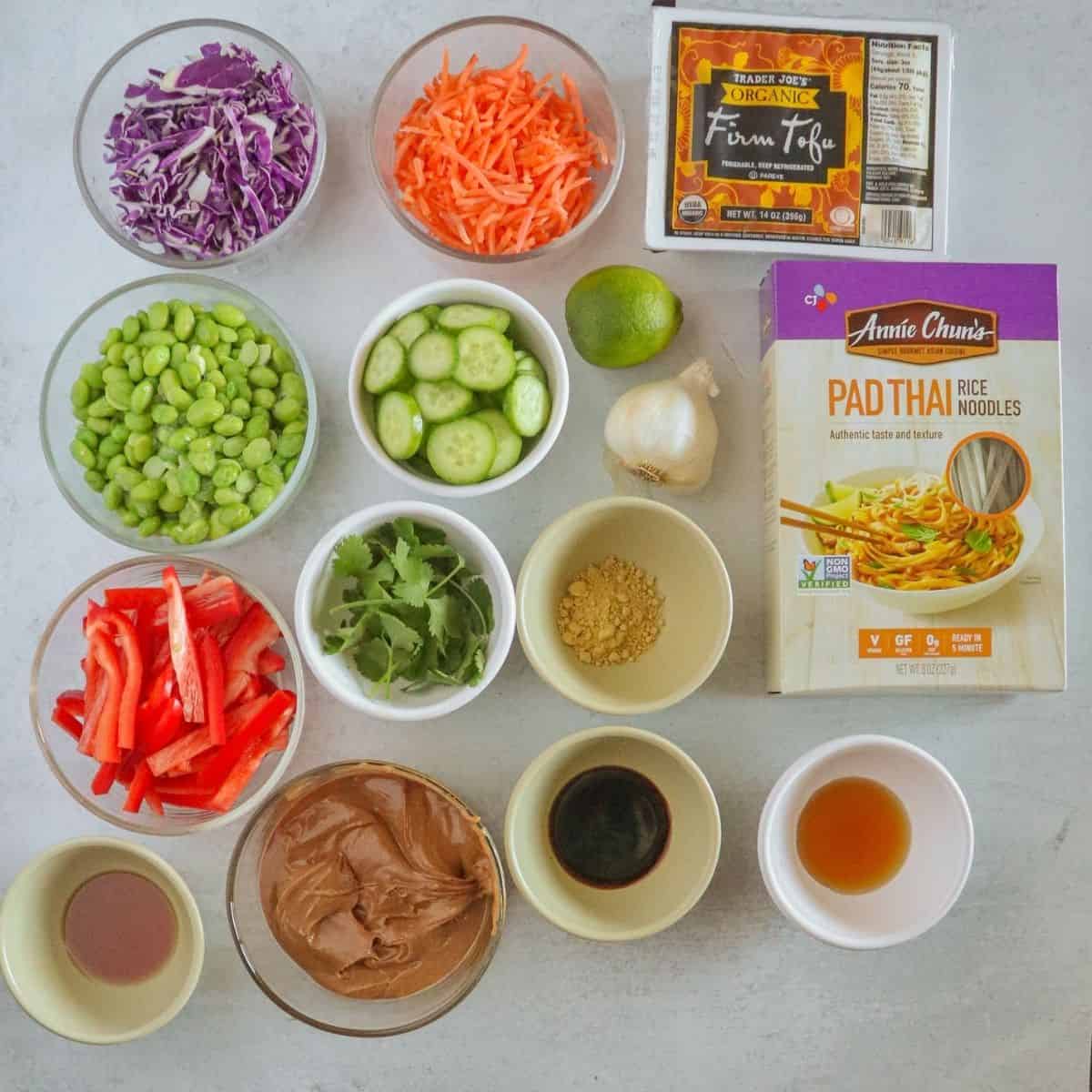 Bowls with ingredients and box of noodles on white counter