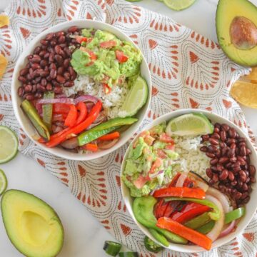 two bowls on multicolored napkin with avocados and cilantro
