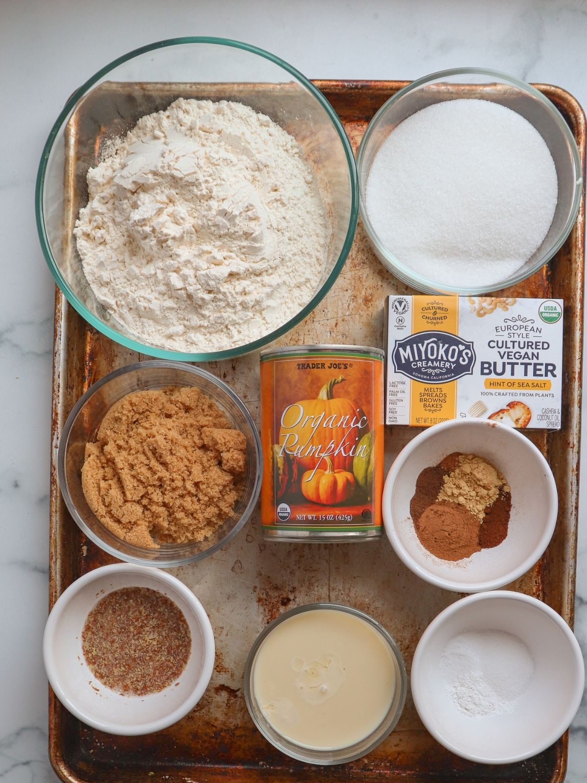 Flour, sugar, vegan butter, pumpkin pie spice, baking powder, salt, vegan buttermilk, flax egg, brown sugar, organic pumpkin