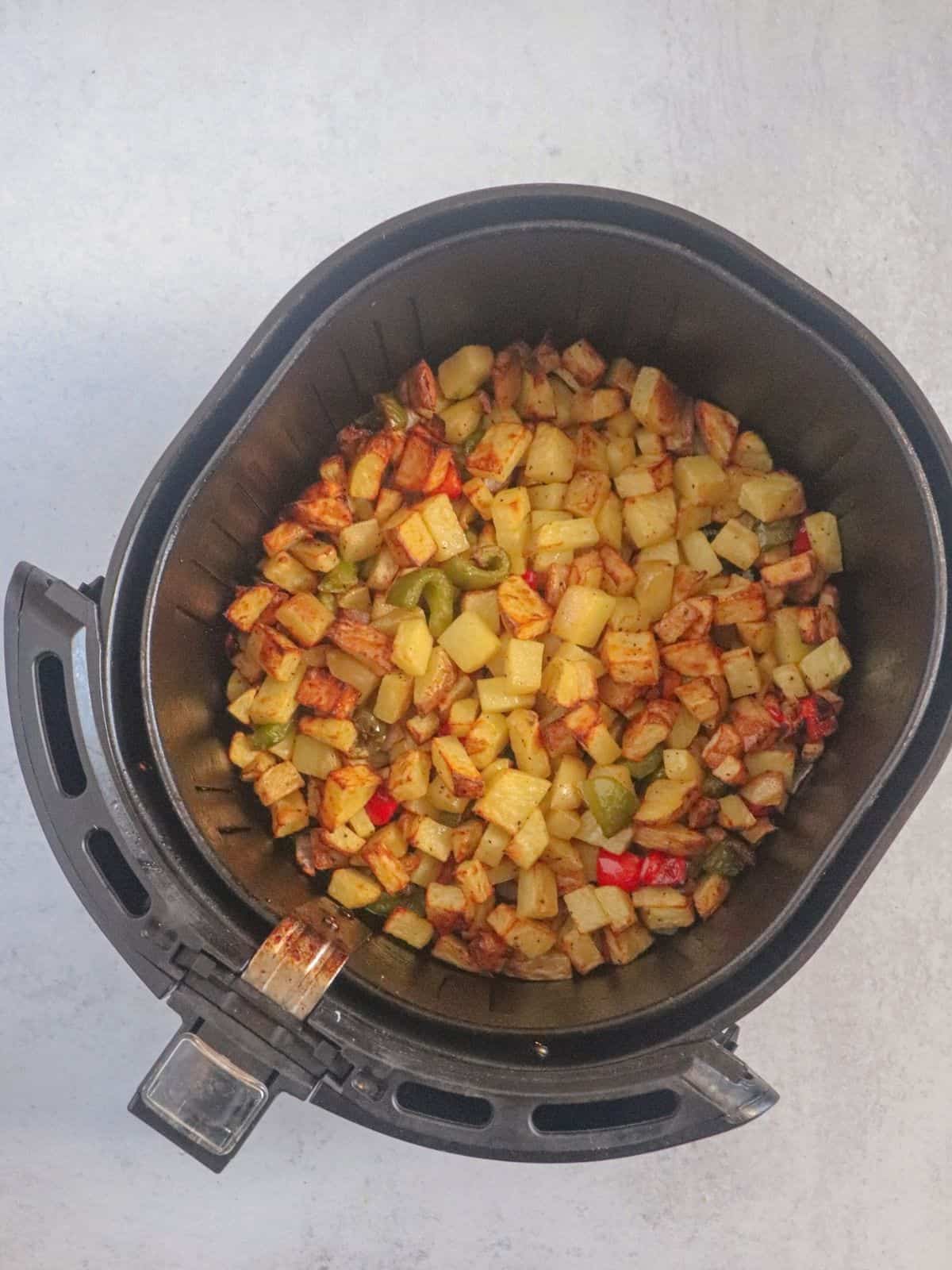 Air Fryer with peppers and vegetables post fry. 