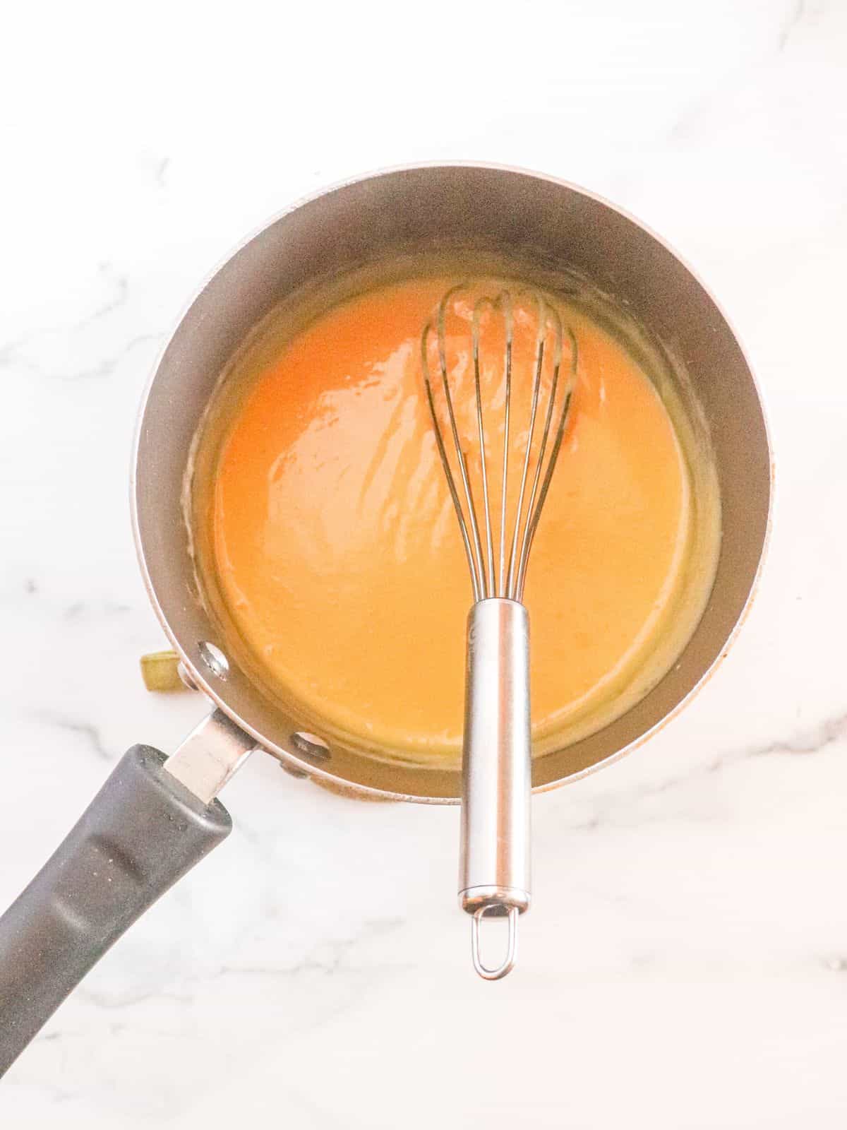Nonstick pan with whisk and custard inside
