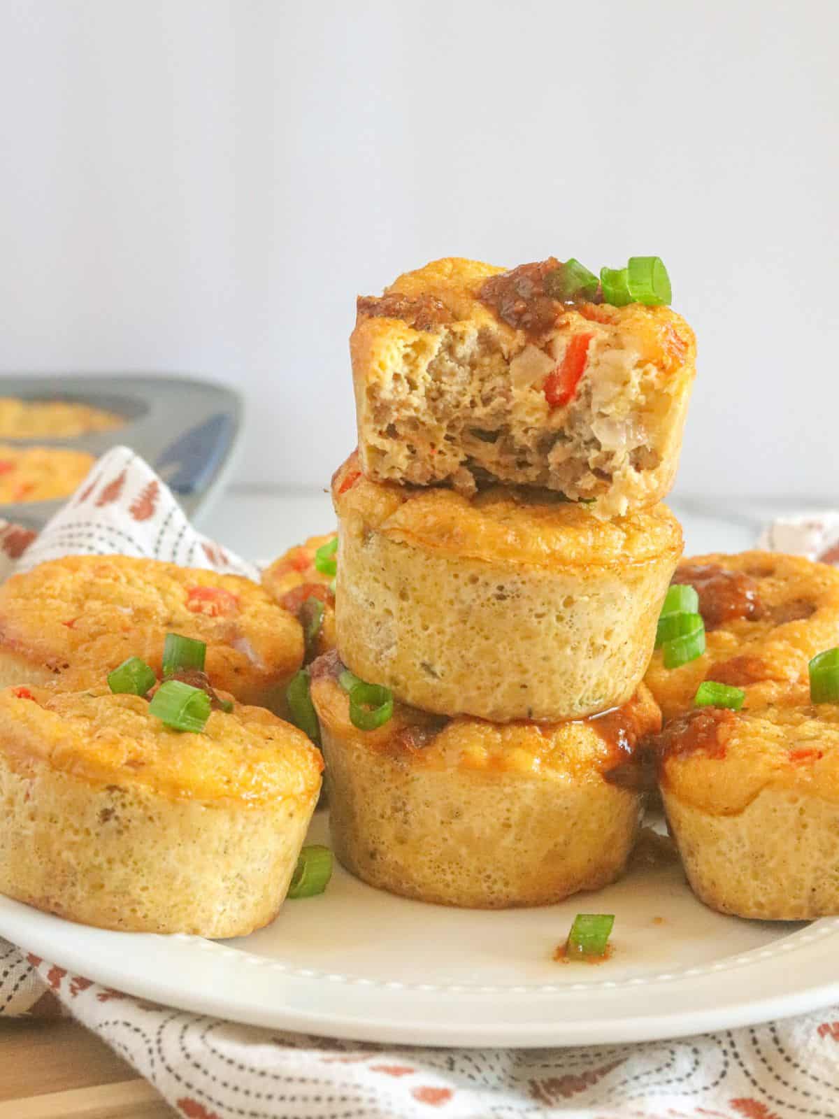 stacked breakfast muffins on white plate