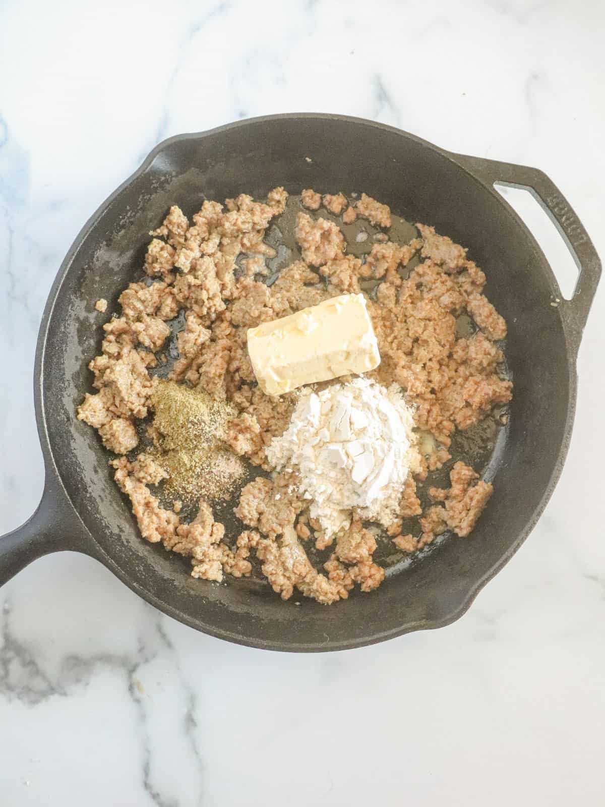 flour and butter added to skillet with sausage